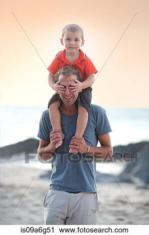 Father carrying son on shoulders View Large Photo Image Stock Image - Father carrying son on shoulders. Fotosearch