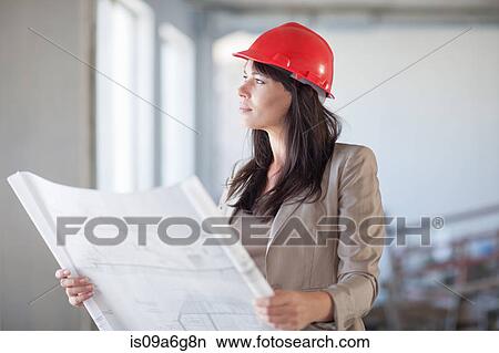 Female architect holding blueprint View Large Photo Image Picture - Female architect holding blueprint. Fotosearch