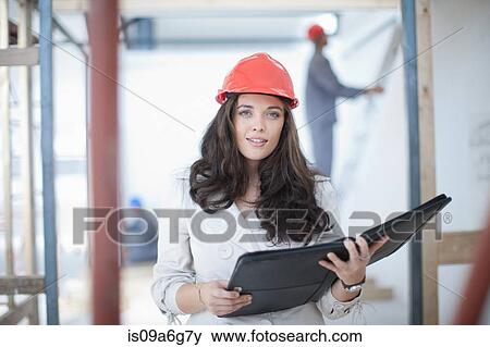 Female architect with portfolio on construction site View Large Photo Image Stock Photo - Female architect with portfolio on construction site. Fotosearch