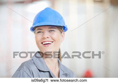 Female construction worker with blue hard hat View Large Photo Image Stock Photograph - Female construction worker with blue hard hat. Fotosearch