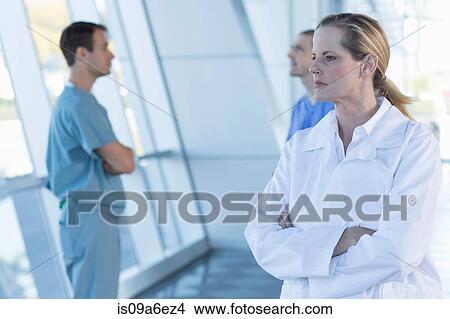 Picture - Female doctor with arms folded. Fotosearch