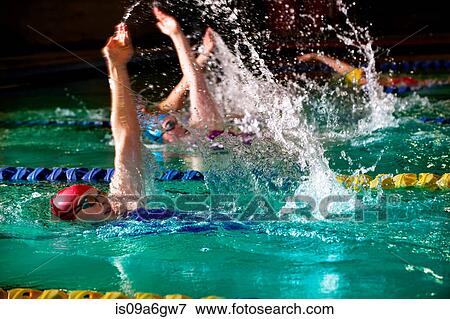 Female swimmers doing backstroke in swimming pool View Large Photo Image Stock Photo - Female swimmers doing backstroke in swimming pool. Fotosearch