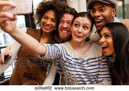 Friends taking photos using smart phone View Large Photo Image Stock Image - Friends taking photos using smart phone. Fotosearch