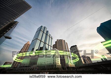 Green light trails surrounding skyscrapers View Large Photo Image Stock Photo - Green light trails surrounding skyscrapers. Fotosearch