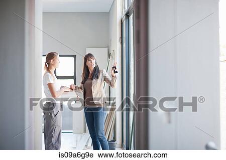 Interior designer and laborer discussing project View Large Photo Image Stock Image - Interior designer and laborer discussing project. Fotosearch
