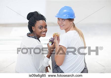 Interior designer and laborer taking lunch break View Large Photo Image Stock Photography - Interior designer and laborer taking lunch break. Fotosearch