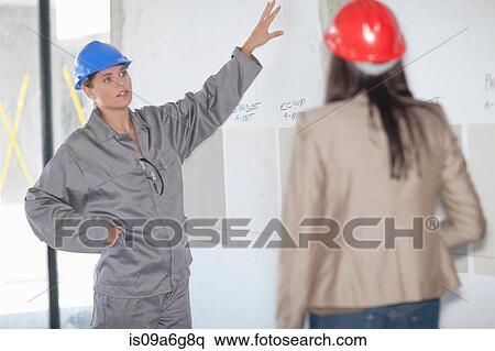 Interior designer and project manager looking at paint swatch View Large Photo Image Stock Photography - Interior designer and project manager looking at paint swatch. Fotosearch