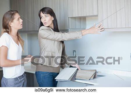 Interior designers discussing kitchen project View Large Photo Image Stock Image - Interior designers discussing kitchen project. Fotosearch