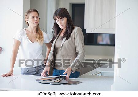 Interior designers discussing swatches in kitchen View Large Photo Image Stock Image - Interior designers discussing swatches in kitchen. Fotosearch
