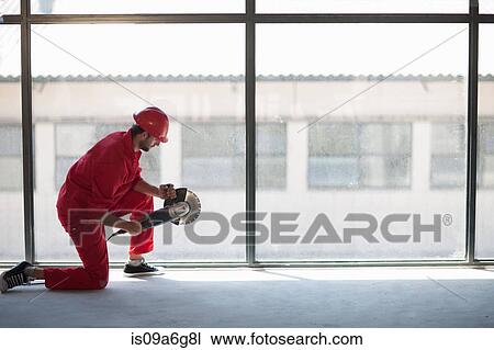 Laborer kneeling in front of window with circular saw View Large Photo Image Stock Image - Laborer kneeling in front of window with circular saw. Fotosearch