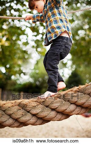 Male toddler crossing rope bridge View Large Photo Image Stock Image - Male toddler crossing rope bridge. Fotosearch