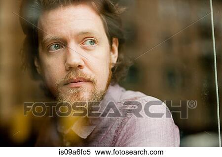 Stock Photography - Man looking out of window. Fotosearch