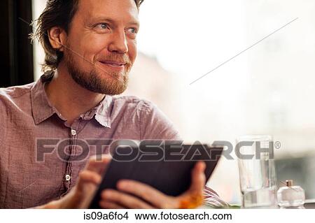 Picture - Man using digital tablet. Fotosearch