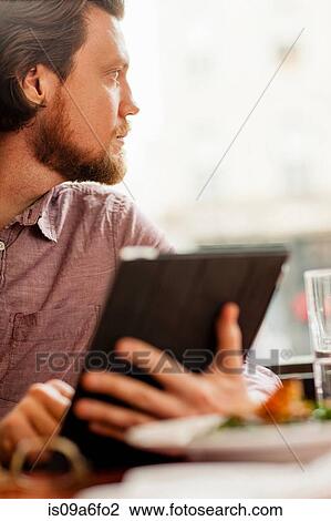 Stock Image - Man using digital tablet. Fotosearch