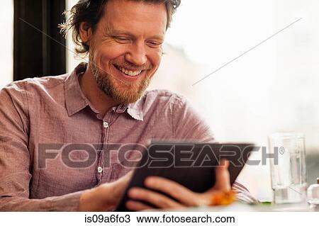 Stock Image - Man using digital tablet. Fotosearch