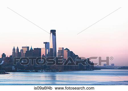Stock Image - Manhattan skyline and waterfront at dusk, New York City, USA. Fotosearch