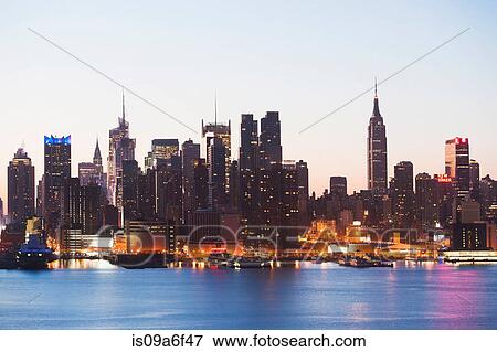 Stock Photo - Manhattan skyline and waterfront at dusk, New York City, USA. Fotosearch