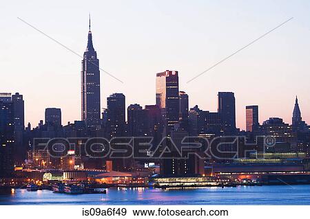 Manhattan skyline and waterfront at dusk, New York City, USA View Large Photo Image Stock Photo - Manhattan skyline and waterfront at dusk, New York City, USA. Fotosearch
