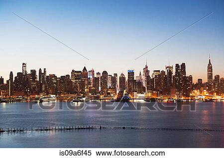 Stock Photography - Manhattan skyline and waterfront at dusk, New York City, USA. Fotosearch