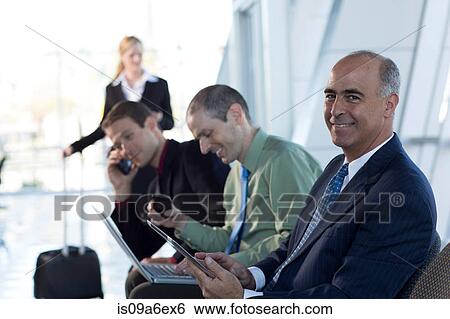 Stock Photograph - Mature businessman using digital tablet. Fotosearch