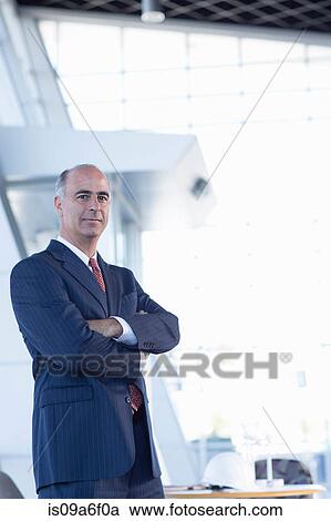 Mature businessman with arms folded View Large Photo Image Stock Image - Mature businessman with arms folded. Fotosearch