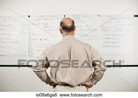 Stock Photograph - Mature man confused by presentation. Fotosearch