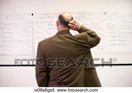 Stock Photography - Mature man confused by presentation. Fotosearch