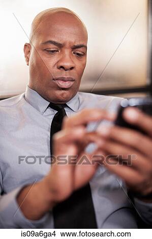 Picture - Mature man using cell phone. Fotosearch
