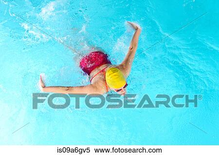 Mature woman doing butterfly stroke in swimming pool View Large Photo Image Stock Photography - Mature woman doing butterfly stroke in swimming pool. Fotosearch