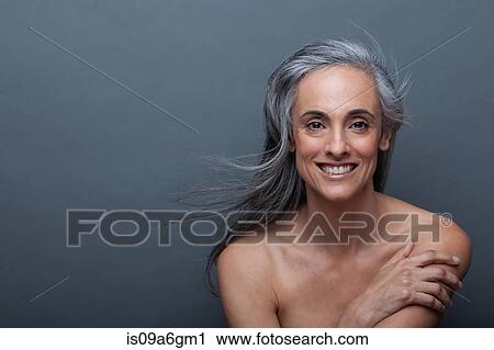 Mature woman touching arm View Large Photo Image Stock Image - Mature woman touching arm. Fotosearch