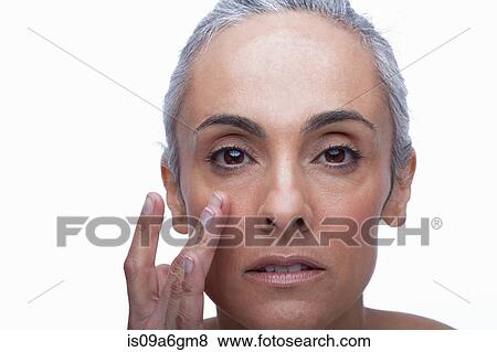 Stock Photo - Mature woman touching face. Fotosearch