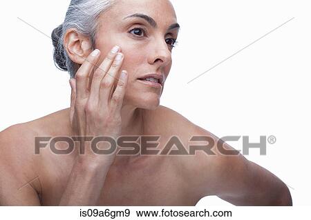 Mature woman touching face View Large Photo Image Stock Photo - Mature woman touching face. Fotosearch