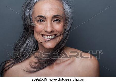 Stock Photo - Mature woman with windswept hair. Fotosearch