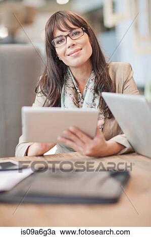 Mid adult businesswoman using digital tablet View Large Photo Image Stock Image - Mid adult businesswoman using digital tablet. Fotosearch