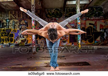 Stock Photograph - Mid adult couple performing modern dance. Fotosearch