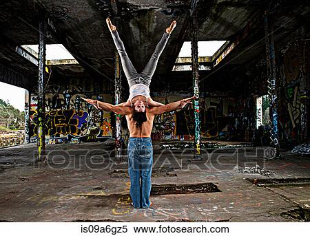 Stock Photography - Mid adult couple performing modern dance. Fotosearch