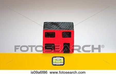 Stock Photograph - Model of house and sprit level. Fotosearch
