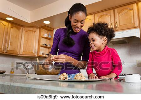 Mother and daughter baking cookies in kitchen View Large Photo Image Stock Photo - Mother and daughter baking cookies in kitchen. Fotosearch