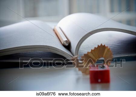 Stock Photograph - Notebook, pencil and pencil sharpener. Fotosearch