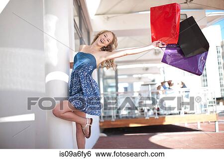 One happy young women swinging shopping bags View Large Photo Image Stock Photograph - One happy young women swinging shopping bags. Fotosearch