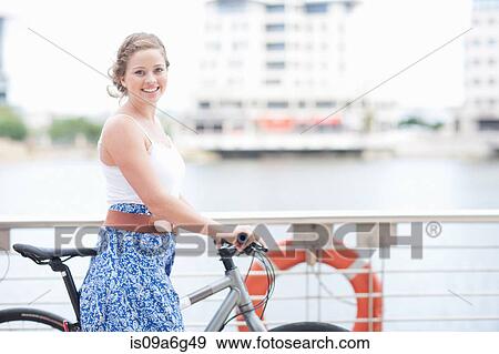 One young woman with her push bike View Large Photo Image Stock Photo - One young woman with her push bike. Fotosearch