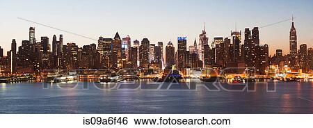 Stock Photograph - Panoramic view Manhattan skyline and waterfront at dusk, New York City, USA. Fotosearch