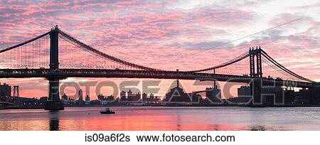 Stock Photograph - Panoramic view of Manhattan bridge at sunset, New York City, USA. Fotosearch