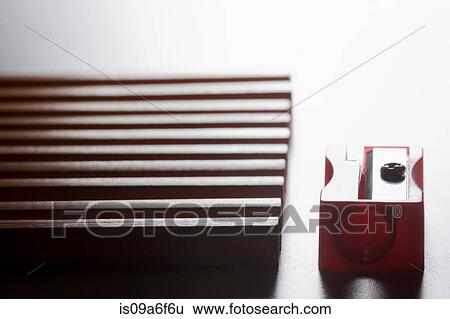 Stock Photograph - Pencils in a row and pencil sharpener. Fotosearch
