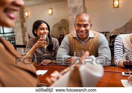 Stock Image - People at wine bar. Fotosearch