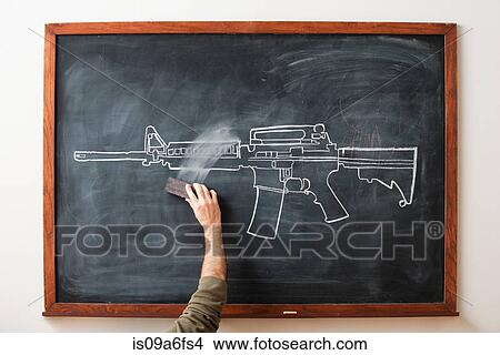 Picture - Person erasing chalk drawing of gun on blackboard. Fotosearch