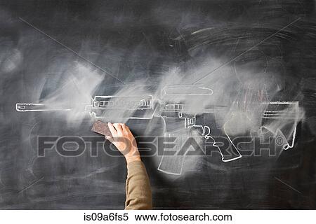 Person erasing chalk drawing of gun on blackboard View Large Photo Image Stock Photography - Person erasing chalk drawing of gun on blackboard. Fotosearch