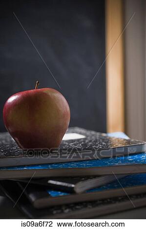Pile of school books with apple View Large Photo Image Stock Image - Pile of school books with apple. Fotosearch