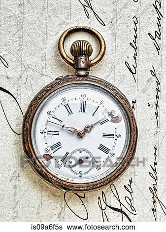 Stock Photograph - Pocket watch on handwritten letter. Fotosearch