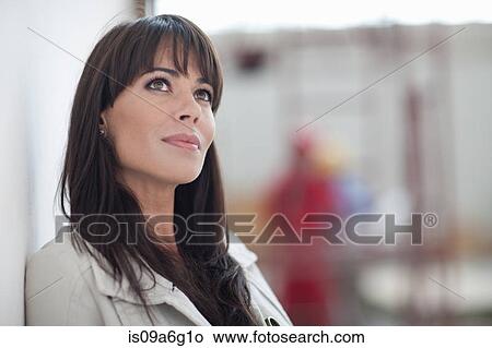 Portrait of a woman looking away in a work environment View Large Photo Image Picture - Portrait of a woman looking away in a work environment. Fotosearch